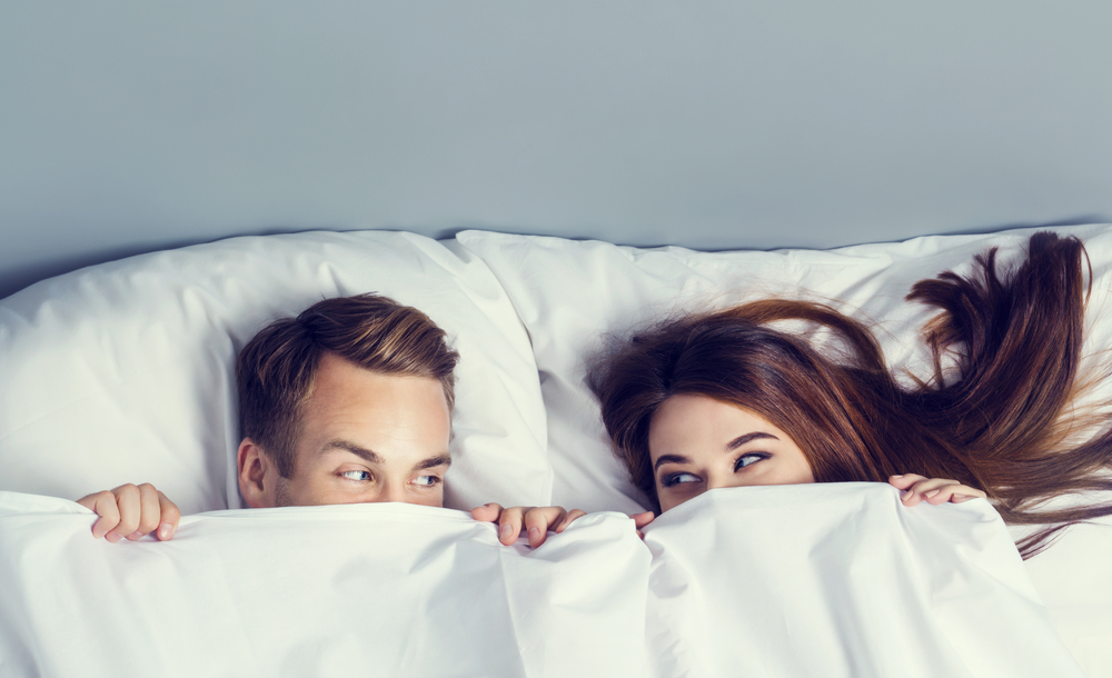 a couple cuddling in bed